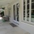 Clean covered patio with white walls and glass doors